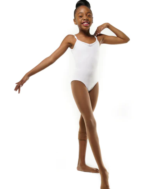 Light brown convertible tights in the color “maven mahogany” on a little Black girl smiling and posing in a white leotard.