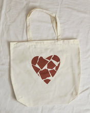 My Nude Shade Organic Canvas Tote Bag with a unique heart design made of broken shapes in earthy tones, symbolizing inclusivity and diversity. Flat-bottom tote shown on a white background.